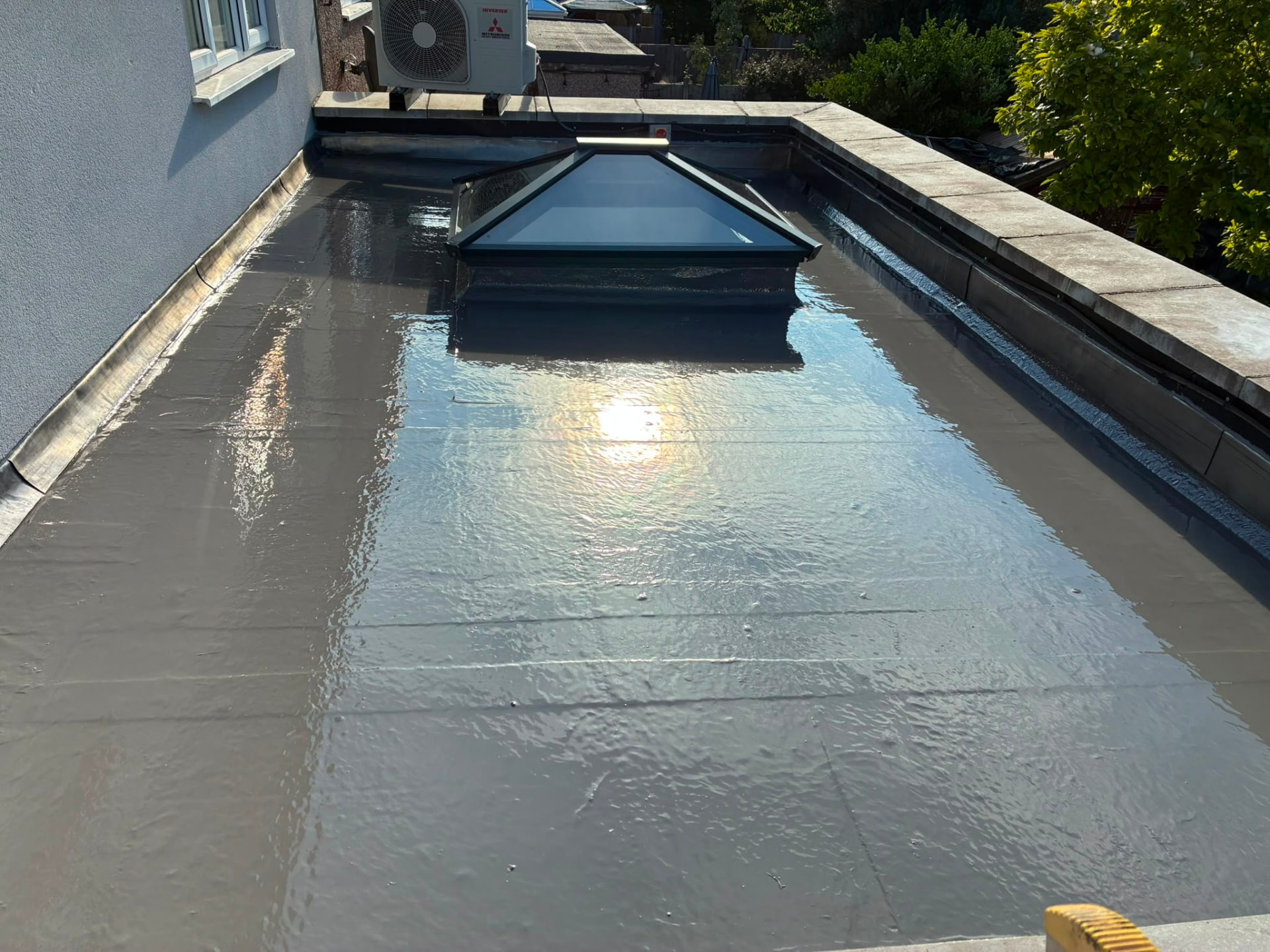 GRP fibreglass flat roof with a glass lantern and lead flashing to the parapet walls